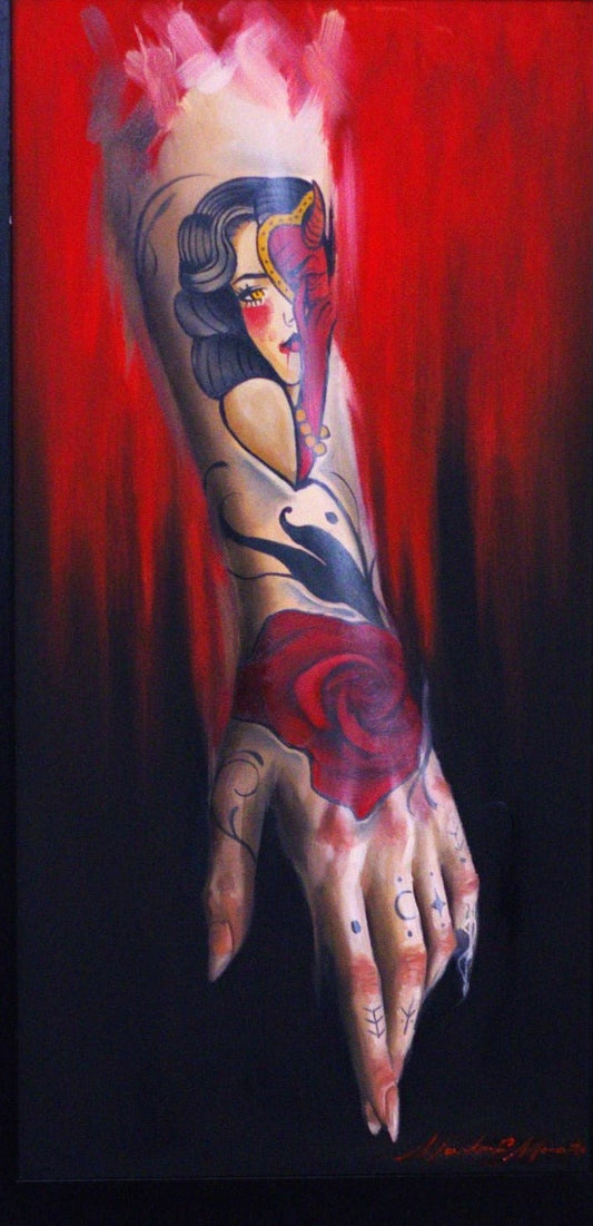 Framed artwork of a tattooed arm with a colorful design on a red background.